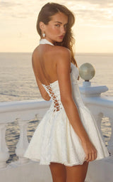 Woman wearing a white lace dress with a scenic background