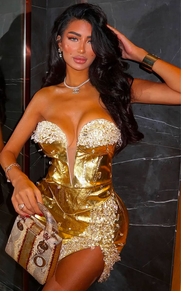 Stylish metallic gold mini dress perfect for cocktail parties, featuring a flattering silhouette and shimmering fabric that catches the light for an elegant, glamorous look."