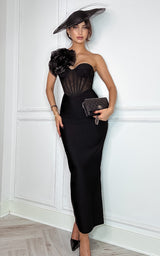 Elegant black bandage midi dress styled for a modern wedding guest, featuring a flattering silhouette and stunning flower applique 