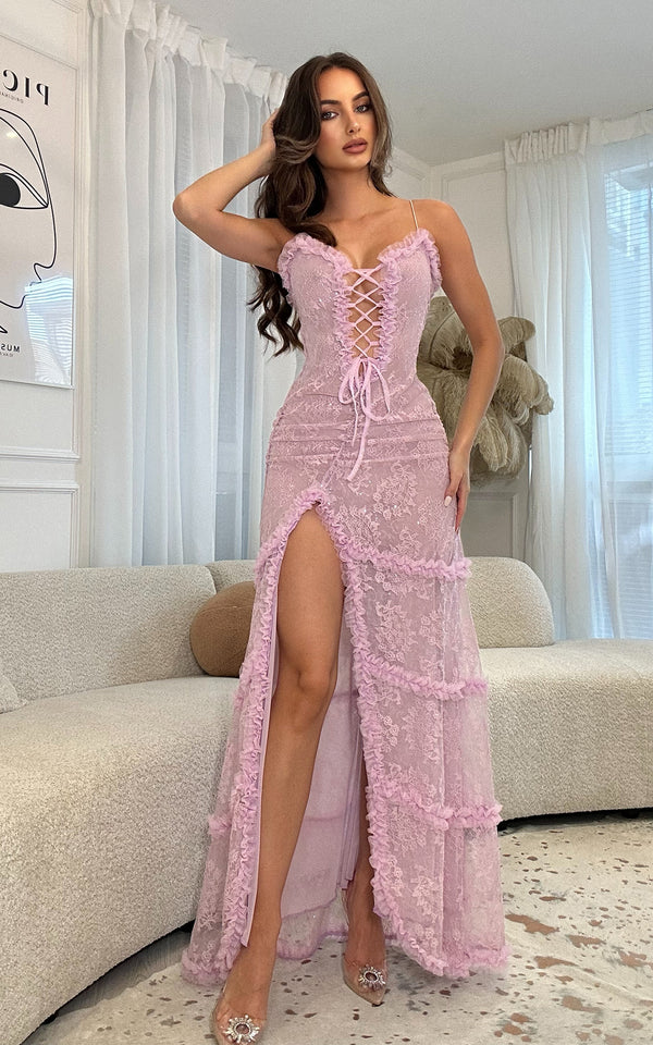 Woman wearing a lilac lace dress in a living room setting