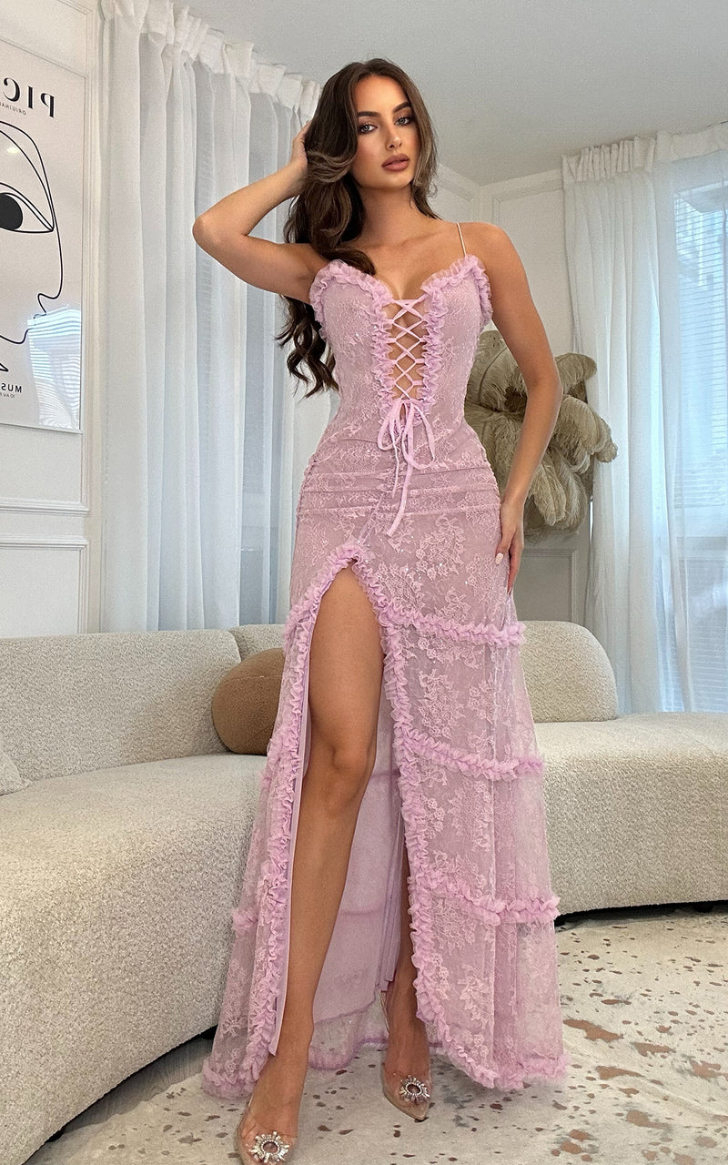 Woman wearing a lilac lace dress in a living room setting